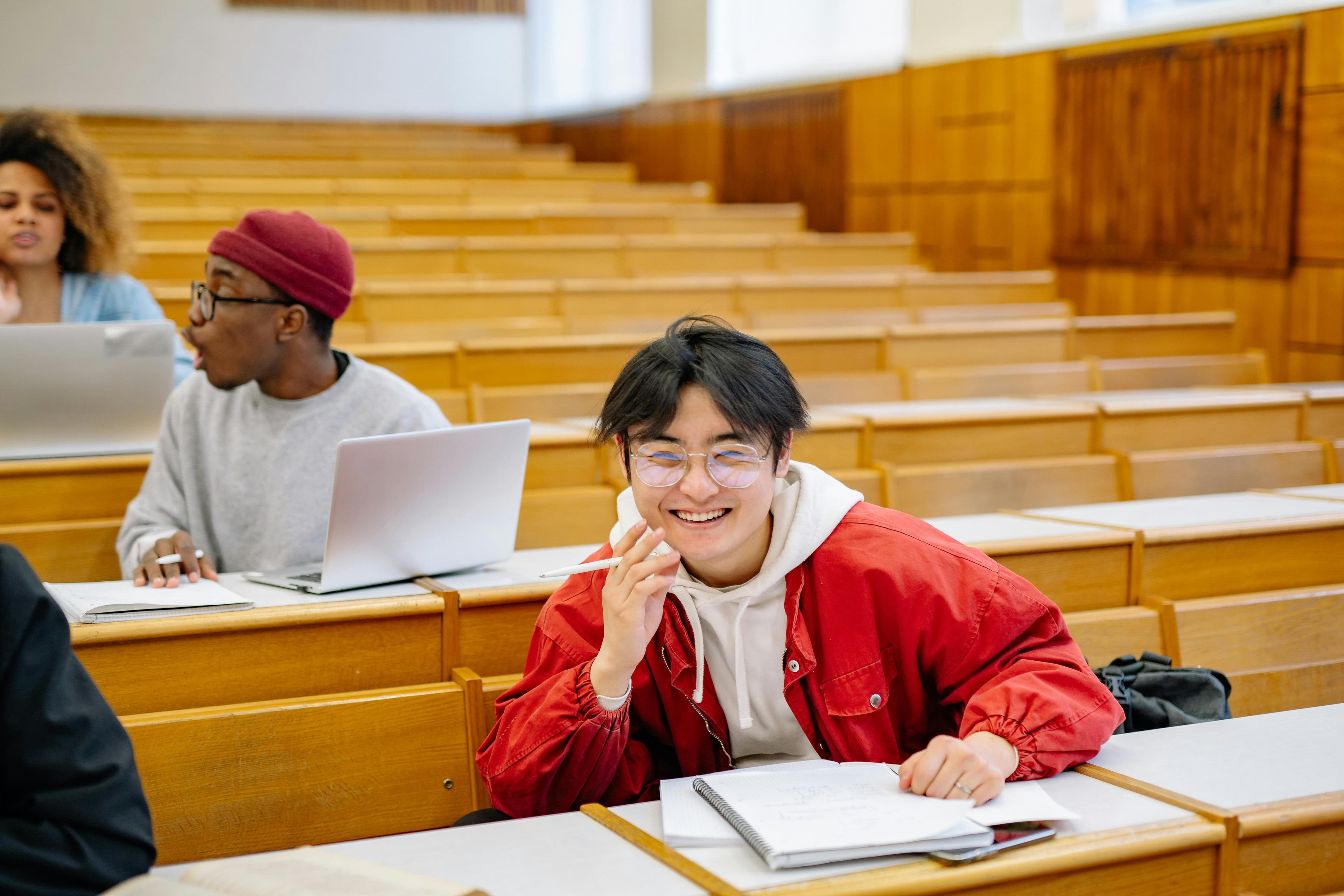 Students studying together with a laptop, notebooks, and notes